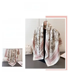 Detailed close-up of large floral silk scarf with elegant pattern and premium texture