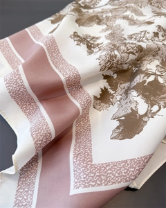 Close-up of vintage floral print on silk-like satin scarf with elegant pink border details
