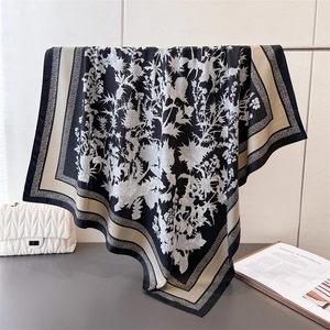 Detail of elegant floral silk square scarf with drape effect and premium texture
