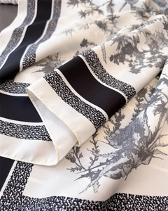Close-up of black and white silk scarf with vintage floral toile de jouy print and fine texture
