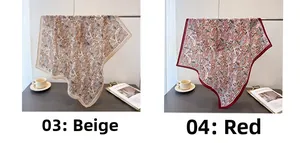 Close-up of beige and red paisley printed square silk scarves with contrasting borders