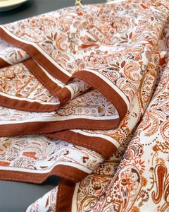 Detailed macro view of vintage paisley pattern on a soft silk-feel elegant neck scarf