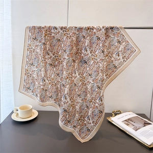 Elegant paisley patterned cotton linen feel square scarf draped in a modern interior setting
