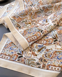 Close-up of vintage paisley pattern on a soft square scarf with elegant wide-stitched edges