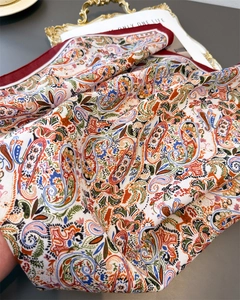 Close-up of vintage paisley pattern scarf with elegant orange and blue silk textures