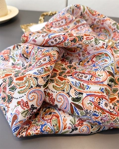 Detailed close-up of colorful paisley pattern on soft cotton-linen feel scarf texture
