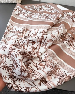 Close-up of vintage brown bamboo print silk scarf with refined twill texture details