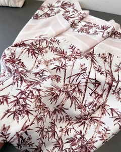 Detailed macro view of bamboo print on smooth faux silk scarf with elegant drapes