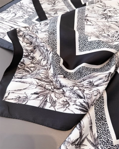 Detail of silk scarf showing black and white bamboo print and fine stitched edges