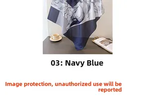Navy blue faux silk scarf with classic leaf prints draped elegantly on a textured table