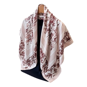 Bamboo print silk scarf in retro Chinese style hanging on a wooden hanger with drape effect