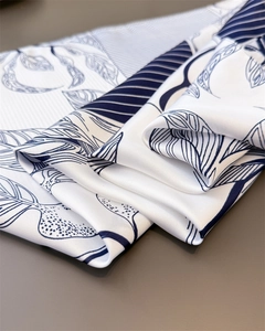 Macro detail of leaf and stripe print on silk-like fabric with elegant draped texture