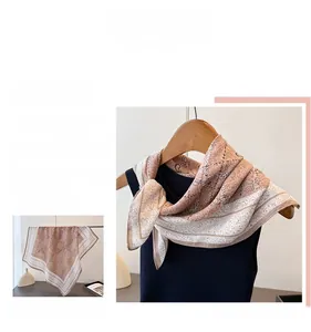 Detail of vintage square scarf with paisley and checkerboard patterns in earthy tones