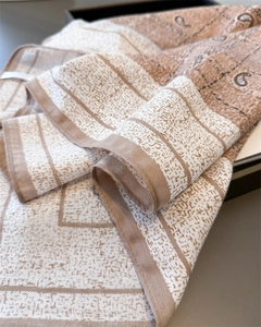 Detailed view of paisley and geometric patterns on soft linen-feel square scarf fabric