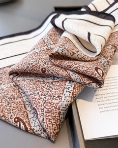 Detailed texture of herringbone cotton linen scarf with abstract geometric patterns