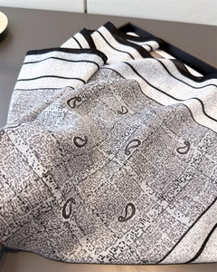 Detailed view of paisley and stripe patterns on a soft cotton-linen blend fashion scarf
