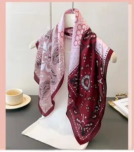 Detail showing gradient satin square scarf with paisley and geometric patterns on a mannequin