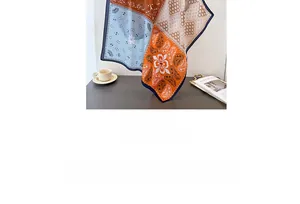 Detail of silk-like paisley square scarf in orange and blue with satin finish
