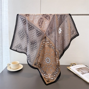 Elegant patchwork paisley silk scarf in earth tones featuring geometric star patterns