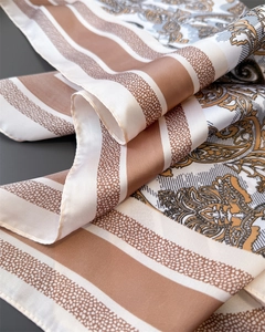 Detailed macro view showing paisley pattern and silk texture on the vintage brown scarf