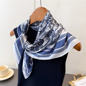 Close-up of blue and white paisley silk scarf with elegant geometric patterns and prints