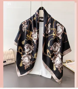 Detail of floral chain print silk scarf showing white roses and golden accents