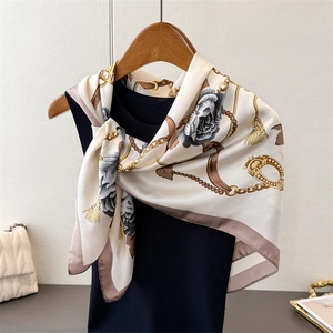 Elegant floral chain silk-feel scarf wrap for women on minimalist hanger display