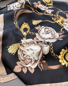 Detailed view of silk satin scarf featuring luxury gold chain and rose floral prints