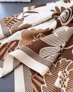 Macro detail of retro floral silk-like scarf showing smooth texture and twill pattern