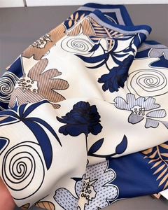 Detailed shot of vintage floral patterns on silky satin square scarf fabric