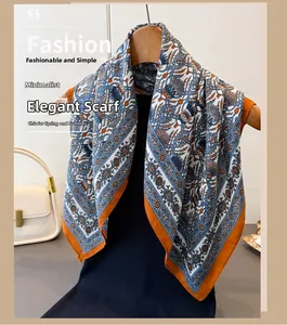 Detail of elegant herringbone cotton linen scarf with orange border on wooden hanger