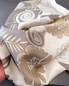Detailed close-up of premium satin scarf fabric with retro floral prints and smooth folds