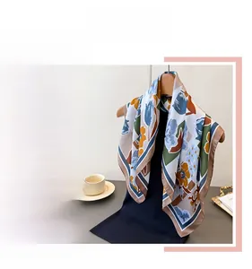 Detail of elegant floral print silk-feel square scarf with premium rolled hem edges