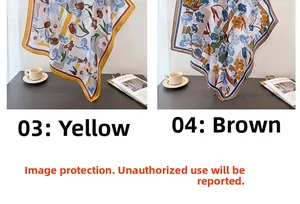 Floral silk-like square scarves in yellow and brown displayed on a home desk setup