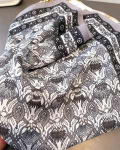Close-up of vintage herringbone cotton-linen feel scarf with gray floral paisley pattern