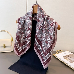 Retro herringbone pattern floral square silk scarf styled on a black knit sweater