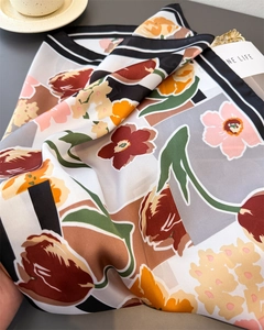 Detail of silk-like scarf featuring realistic tulip prints and bold contrast borders