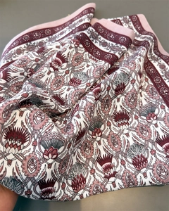 Detail of vintage herringbone scarf featuring intricate burgundy and green floral patterns