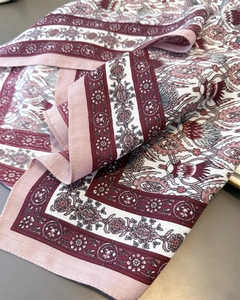 Close-up of herringbone cotton linen scarf with vintage floral patterns and soft texture