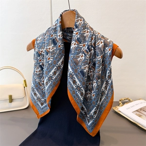 Vintage paisley silk-feel square scarf with floral print and orange borders on hanger