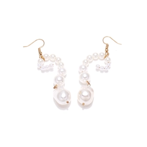 Macro shot of gold hook earrings with spiral faux pearls and baroque pearl pendant