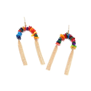 Close-up of bohemian colorful gravel beads and golden metal chain fringe earrings