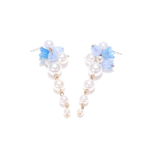 Detail of beaded floral long tassel earrings with faux pearls and blue resin petals