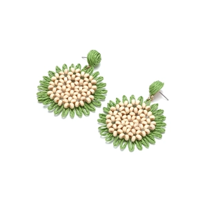 Detail of bohemian woven raffia sunflower earrings with center wood beads and green petals