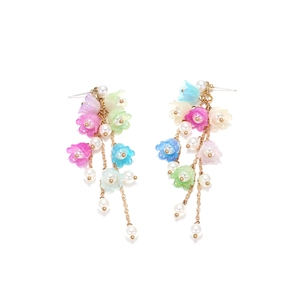 Close-up of lily of the valley tassel earrings with colorful resin flowers and pearls