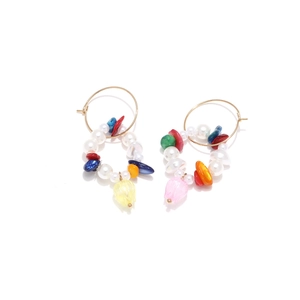 Detailed shot of bohemian hoop earrings with colorful stones and tulip flower charms