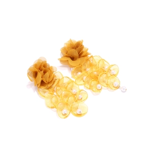 Detailed view of handmade ginger yellow mesh flower earrings with white faux pearl tassels