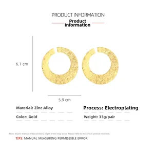 Detail view of retro gold hoop earrings with hammered texture and precise size dimensions