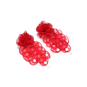 Detail of red mesh petal tassel earrings featuring elegant white pearl embellishments
