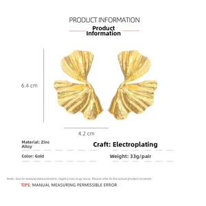 Detail showing gold ginkgo leaf earrings size 6.4cm x 4.2cm made of zinc alloy